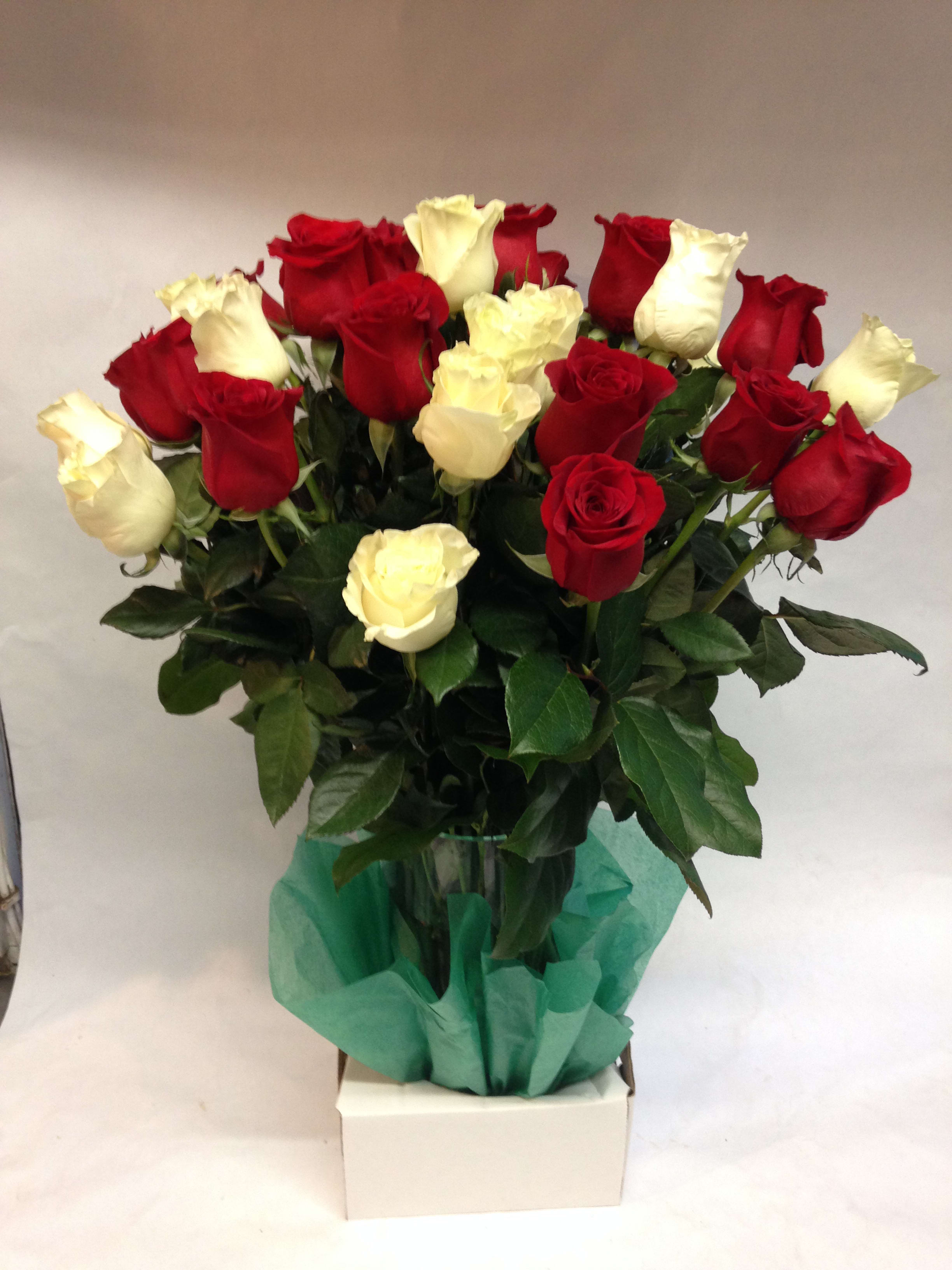 Whites and Reds - This combination of red and white roses consists of 24 premium long stem roses.  (Some flowers may be subject to change depending on the season. We will contact you with available flower substitutions; please contact us with specific questions if you are concerned with flower availability, thanks!)  FEATURED ARRANGEMENT (24 Roses): $198.00 (Regular Price),    36 Roses: $288.00 (Deluxe Price),    48  Roses $378.00 (Premium Price).  
