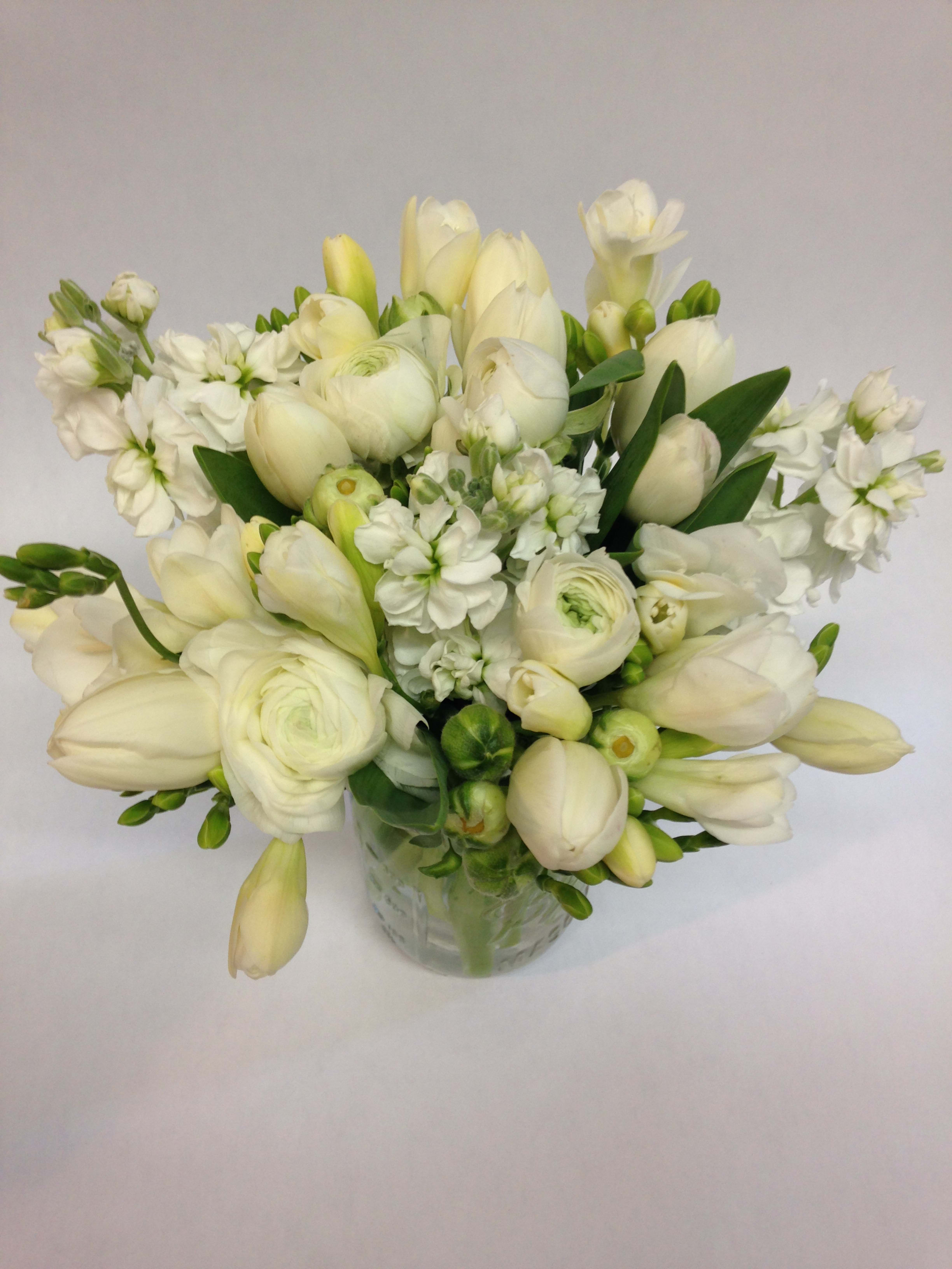 Simple and Fragrant white flowers Arrangement (Pre-order) - This elegant arrangement celebrates the timeless beauty of whites and greens, proving that simplicity can be just as striking as more colorful designs. Created by a skilled San Francisco florist, it showcases fresh seasonal blooms in crisp white tones paired with lush greenery for a clean, modern look that feels both calming and sophisticated. The balance of textures makes it versatile—equally suited for home décor, office spaces, weddings, sympathy gifts, or simply as a thoughtful gesture for someone who loves understated beauty.    Designed with care, this arrangement is meant to highlight the natural elegance of flowers without distraction, allowing each stem to shine. As with all our floral creations, some blooms may be subject to seasonal change, and we’ll always contact you to confirm any substitutions so that your arrangement arrives looking just as stunning. For specific questions about flower availability, feel free to reach out to your local San Francisco florist—we’re here to help.  Featured Arrangement: $135.75 (Regular Price)