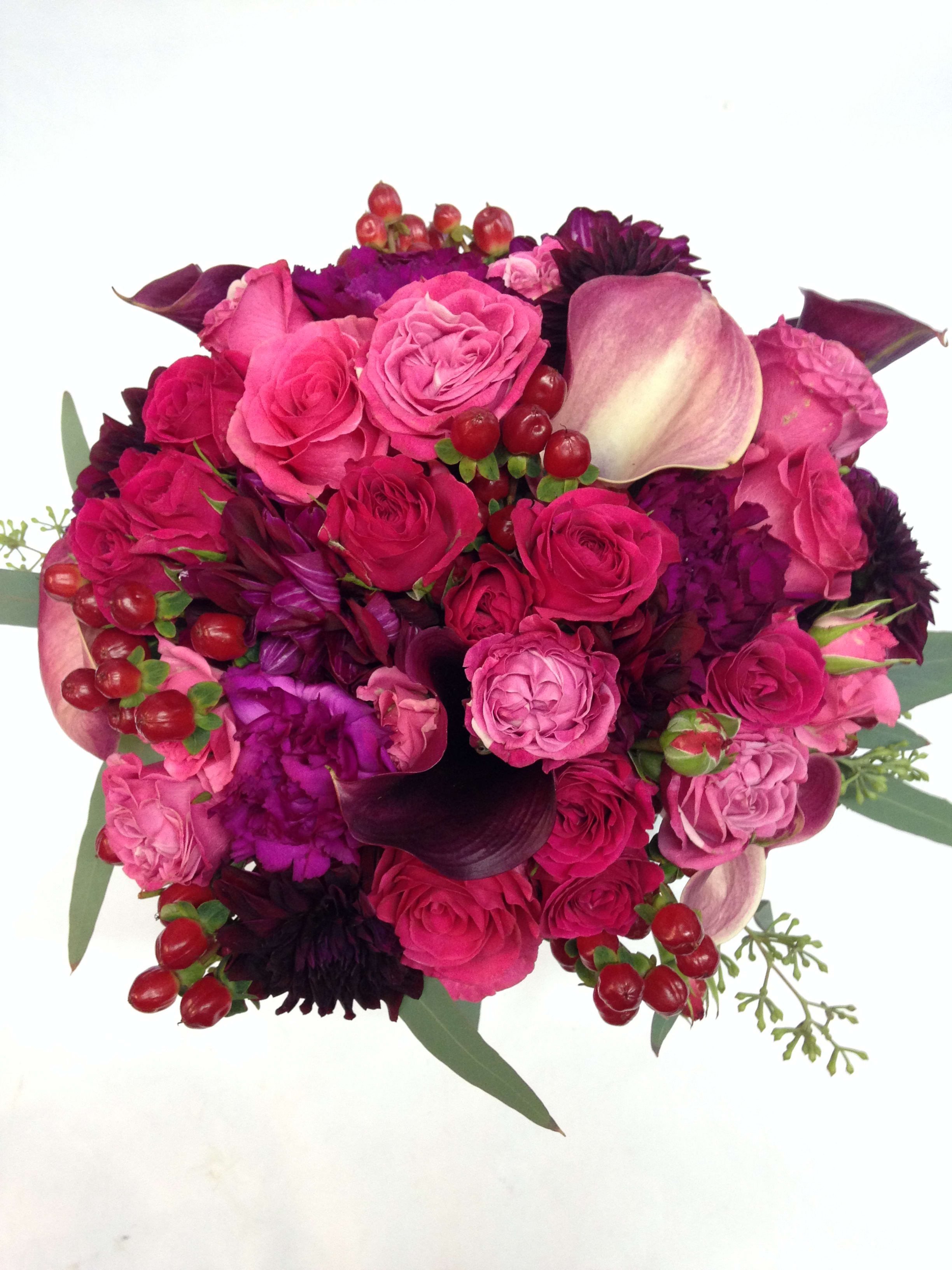 Pink and purple bouquet with roses, calla lilies, and berries