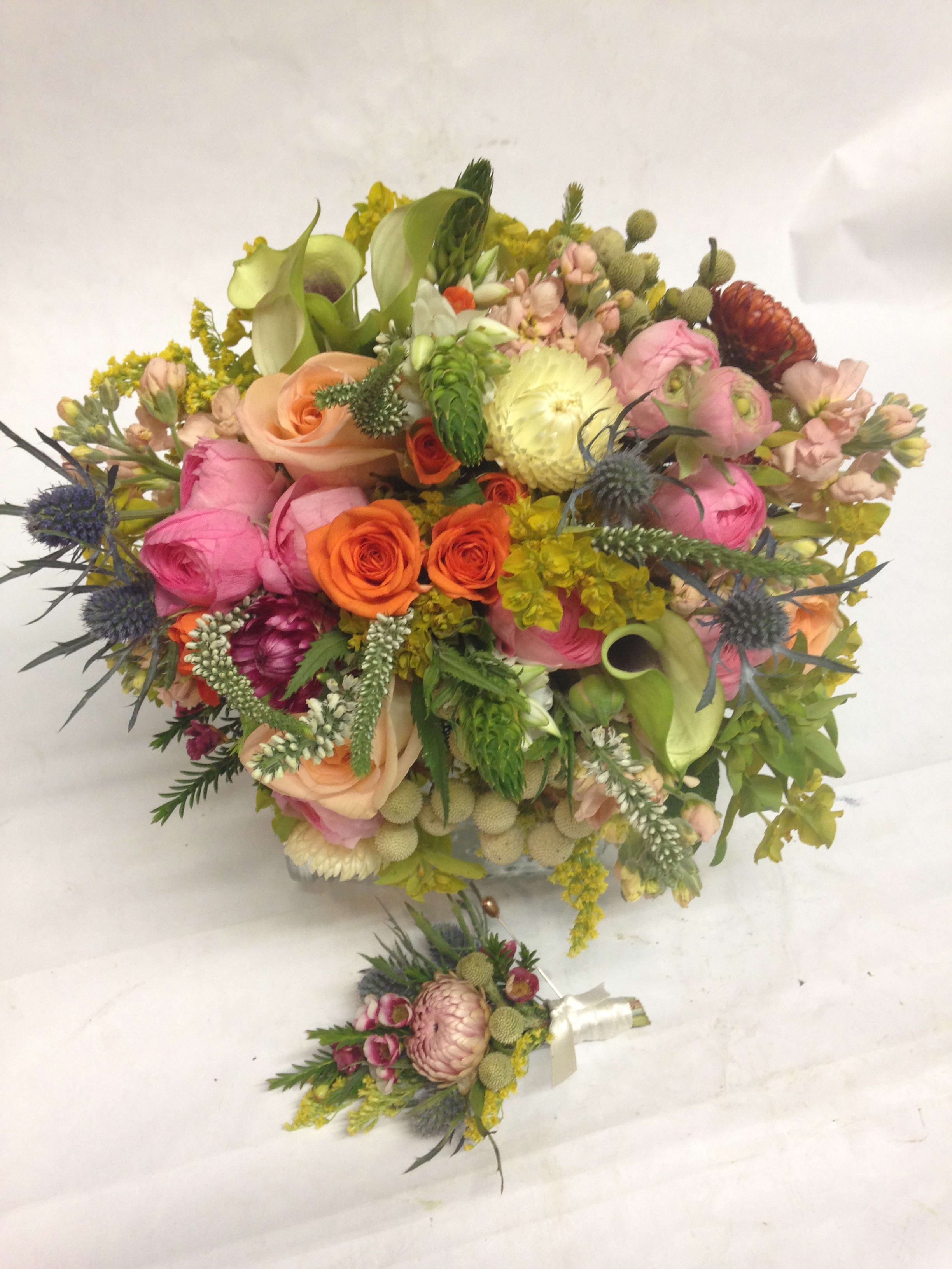 Colorful mixed bouquet with roses, calla lilies, and thistle