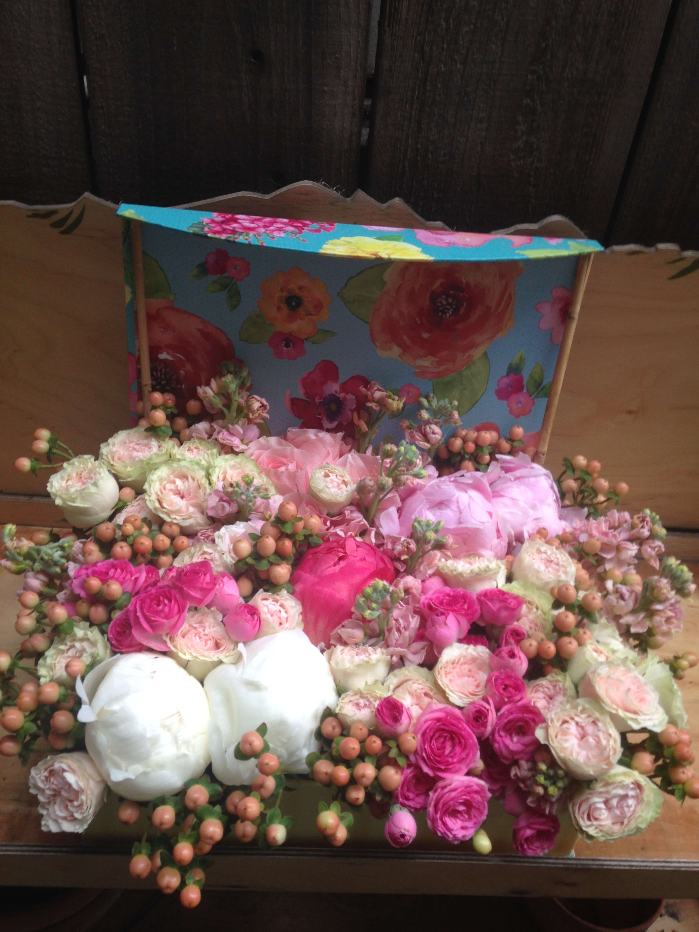 Mixed pink and white flower arrangement in a decorative box