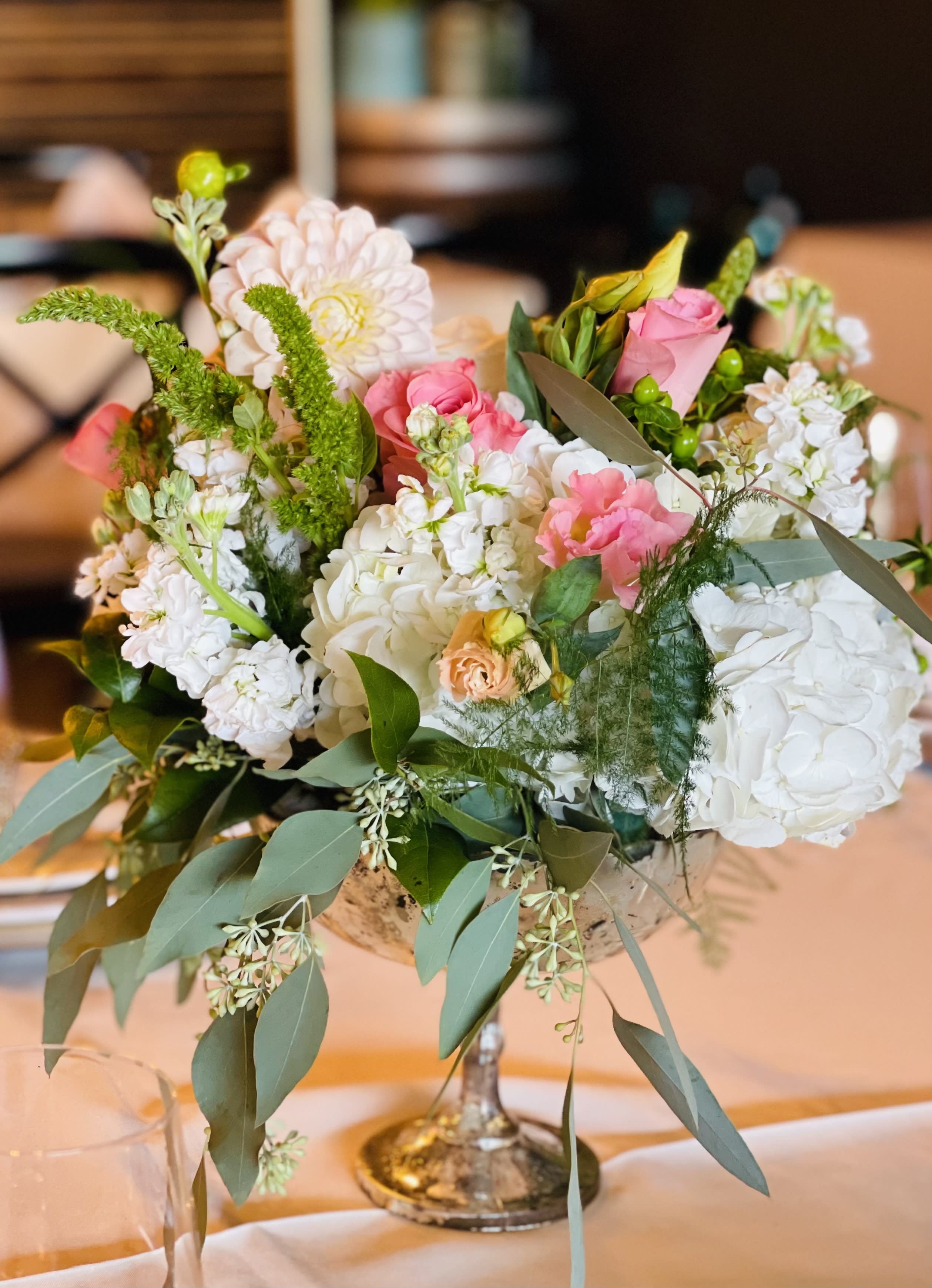 Mixed pink and white floral arrangement in a silver vase