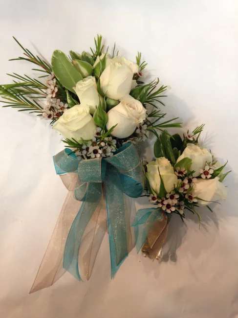 White rose bouquet with blue ribbon and matching boutonniere