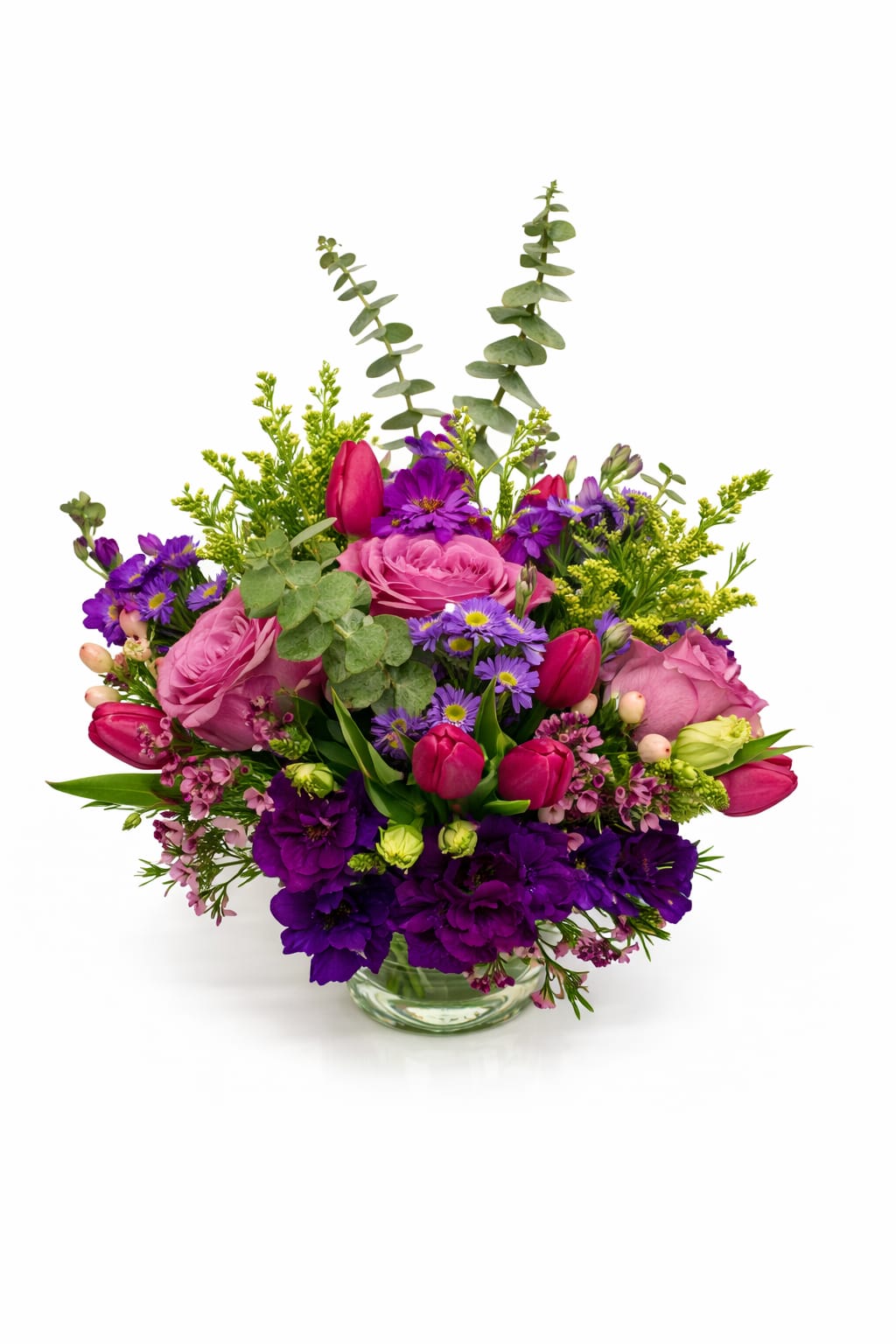 Pink and purple mixed bouquet in a clear glass vase