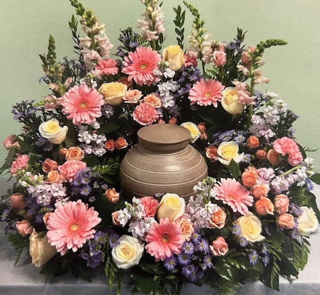 Pastel Urn Wreath U27  - This lovely pastel Urn Wreath arrangement is designed to wrap around the urn nestling it in a sea of florals. Upgrading to Deluxe or Premium will add more flowers to your design. **Ribbon Script is an additional $10 