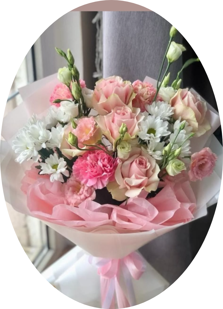 CARNATIONS AND ROSES - A soft, romantic birthday bouquet that reads like a celebration in blush and cream-perfect for anniversaries, Mother's Day, or any moment you want the person you're thinking of to feel truly seen. This rounded hand-tied arrangement pairs blush and cream roses with bright pink carnations and clusters of white daisy-like blooms for a feminine, cheerful impact; the overall impression is airy, layered, and joyful, ideal for marking special days or sending a warm, affectionate message.  The bouquet blends full, open rose heads with smaller daisy clusters and pale lisianthus-like stems to create texture and movement. Wrapped in soft pink and white paper and finished with a pink satin ribbon, it arrives gift-ready with a polished, tender presentation. Available hand-tied (vase option shown on some styles with a clear glass vase), it suits recipients who love classic, romantic color palettes; order with standard sizing and allow care instructions on the delivery card to ensure the blooms stay fresh for several days.