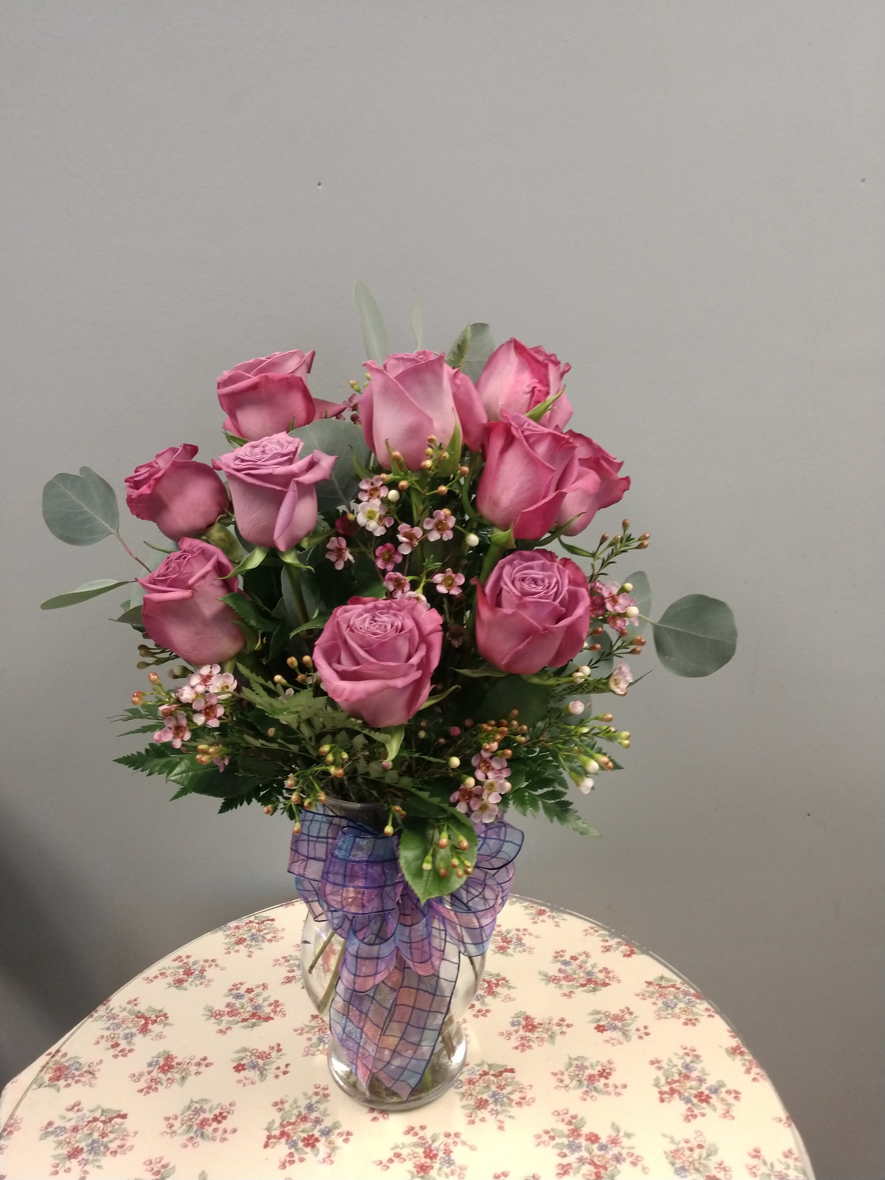 Lavender Love - This arrangement is the perfect "pick me up" to brighten someone's day. Dozen Long Stemmed Lavender Roses is the perfect gift for a birthday, Valentine's day, get well, just because, and thank you.    Arrangement Details: 12 Long Stemmed Lavender Roses, Assorted Greenery and filler flowers.