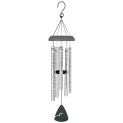 A silver wind chime with hanging metal tubes and a black clapper.