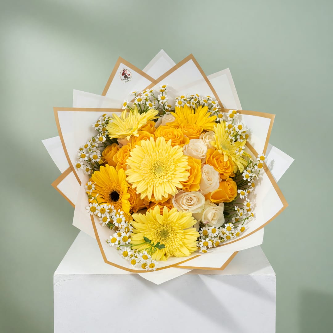 Yellow and white mixed flower bouquet wrapped in white paper