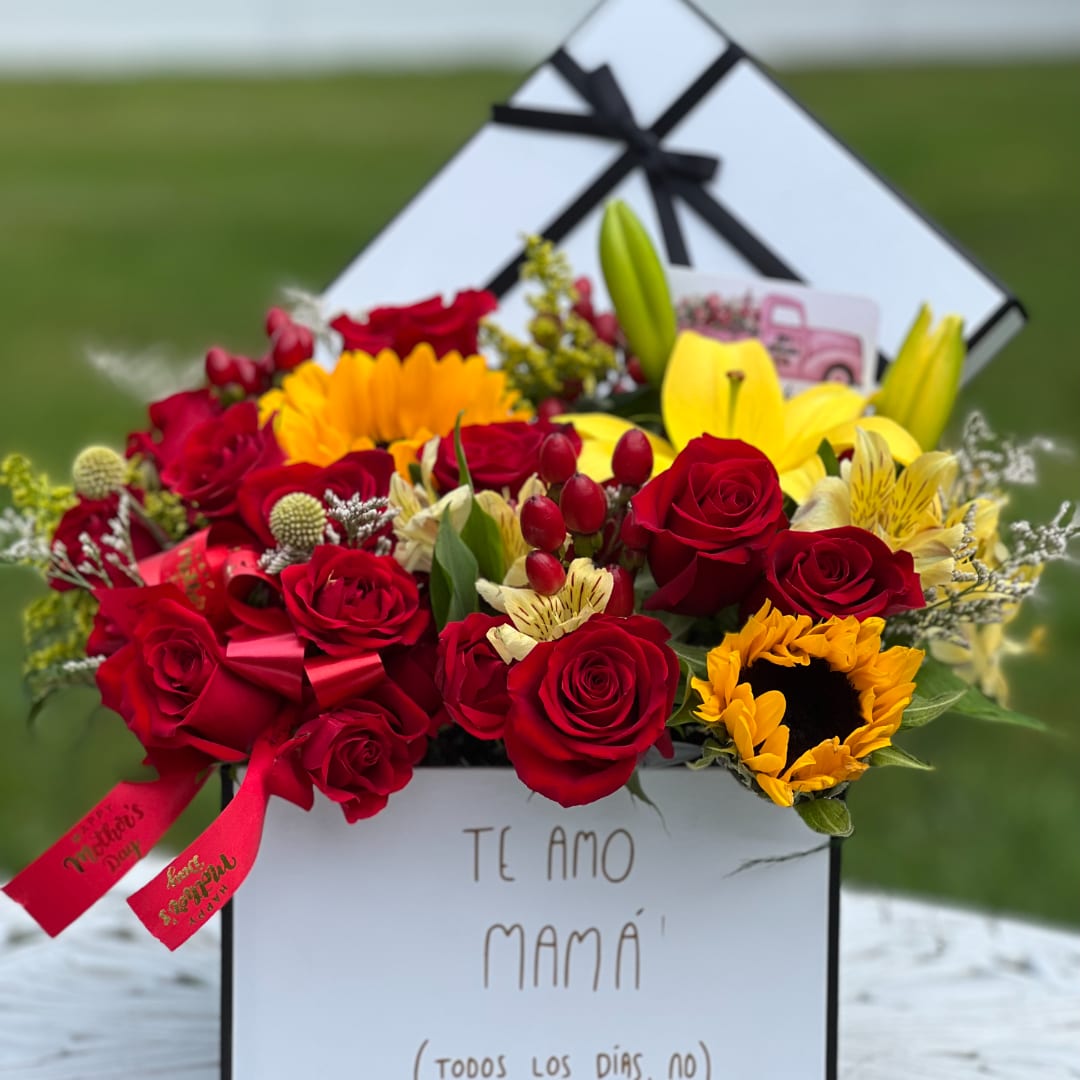 Red roses and yellow flowers in a white gift box with black ribbon