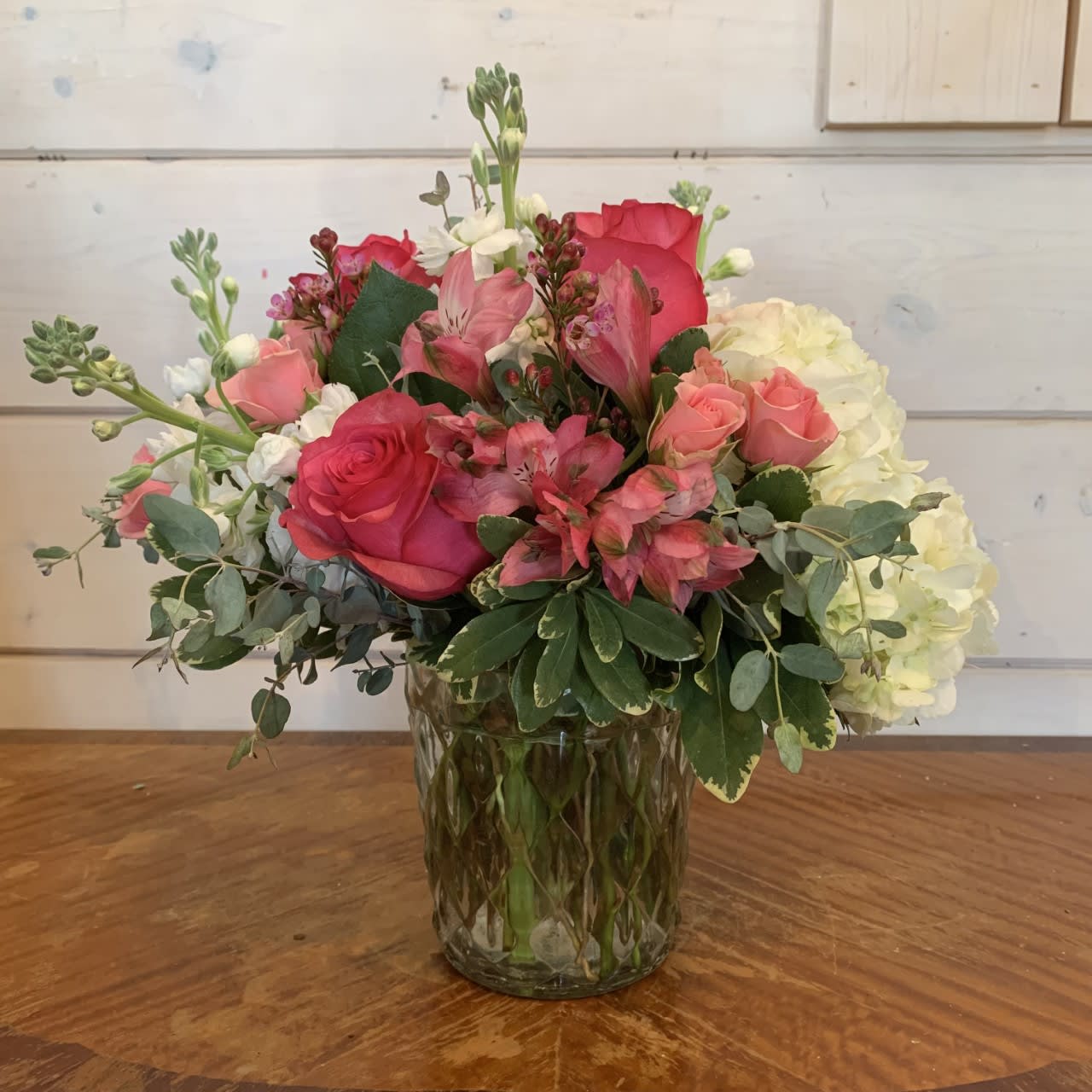 Pink and white flower arrangement in a glass vase