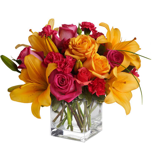 Bouquet of pink and yellow flowers in a clear glass vase