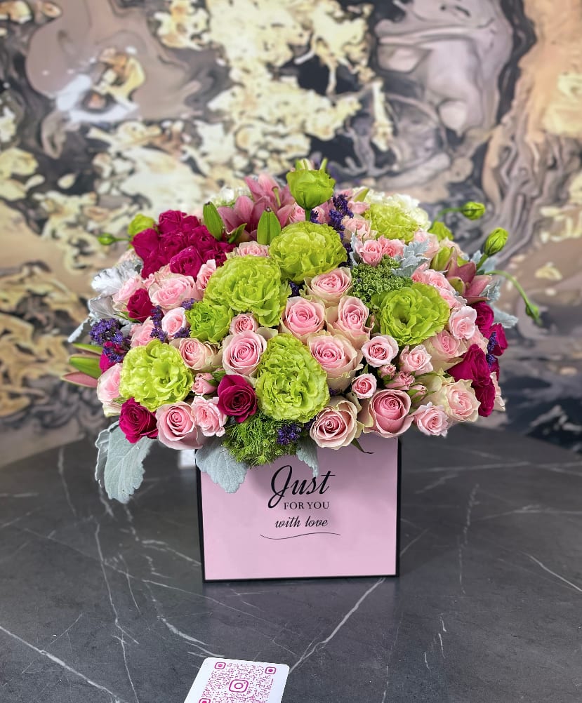 Pink and lime green rose arrangement in a gift box