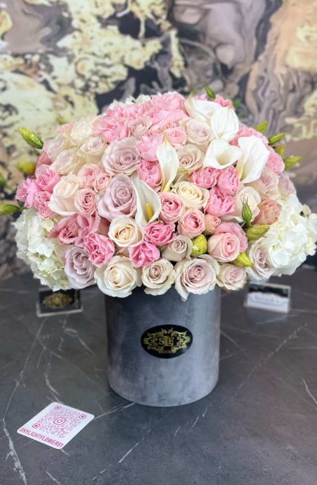 Pink and white rose bouquet in a gray hat box with white calla lilies