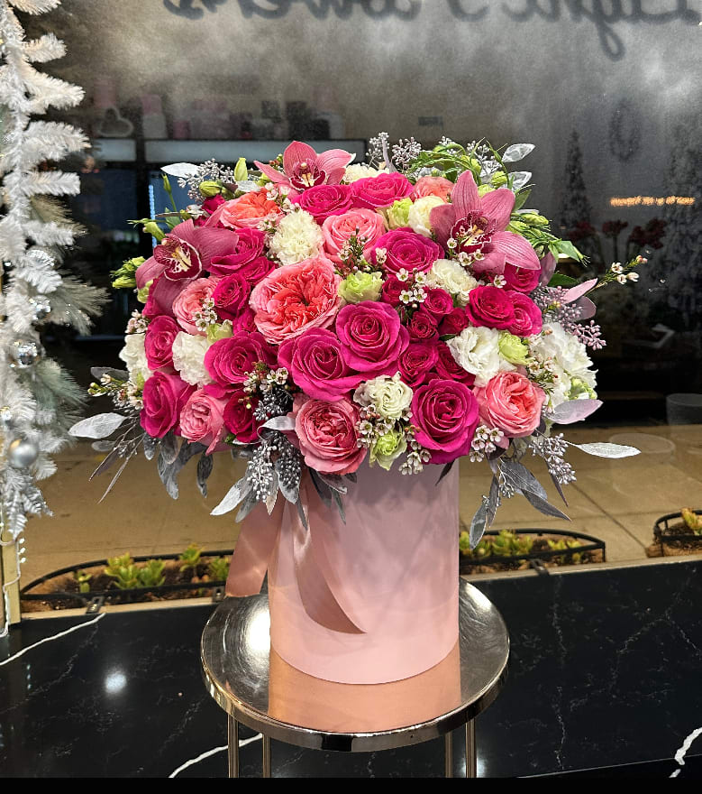 Pink and coral rose arrangement in a blush cylindrical box