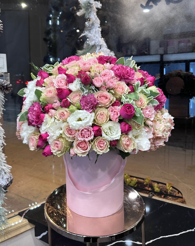 Large pink and white rose arrangement in a pastel box