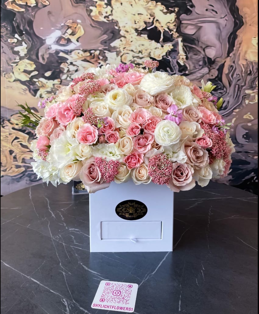 Large pastel bouquet of pink and white roses in a white box