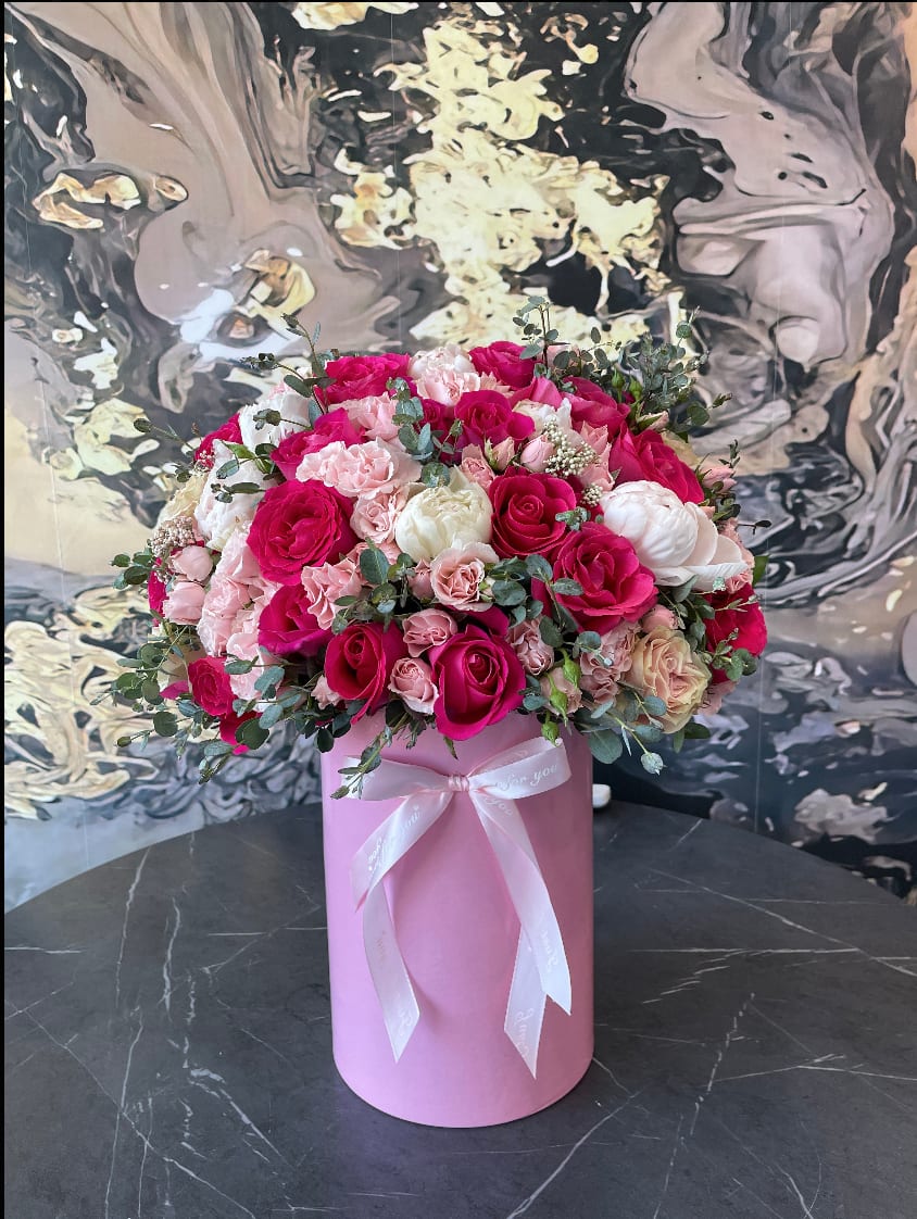 Pink and white rose bouquet in a pink hat box with ribbon