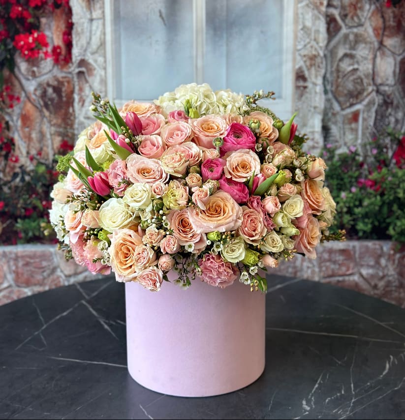 Large pastel bouquet of roses and tulips in a pink box