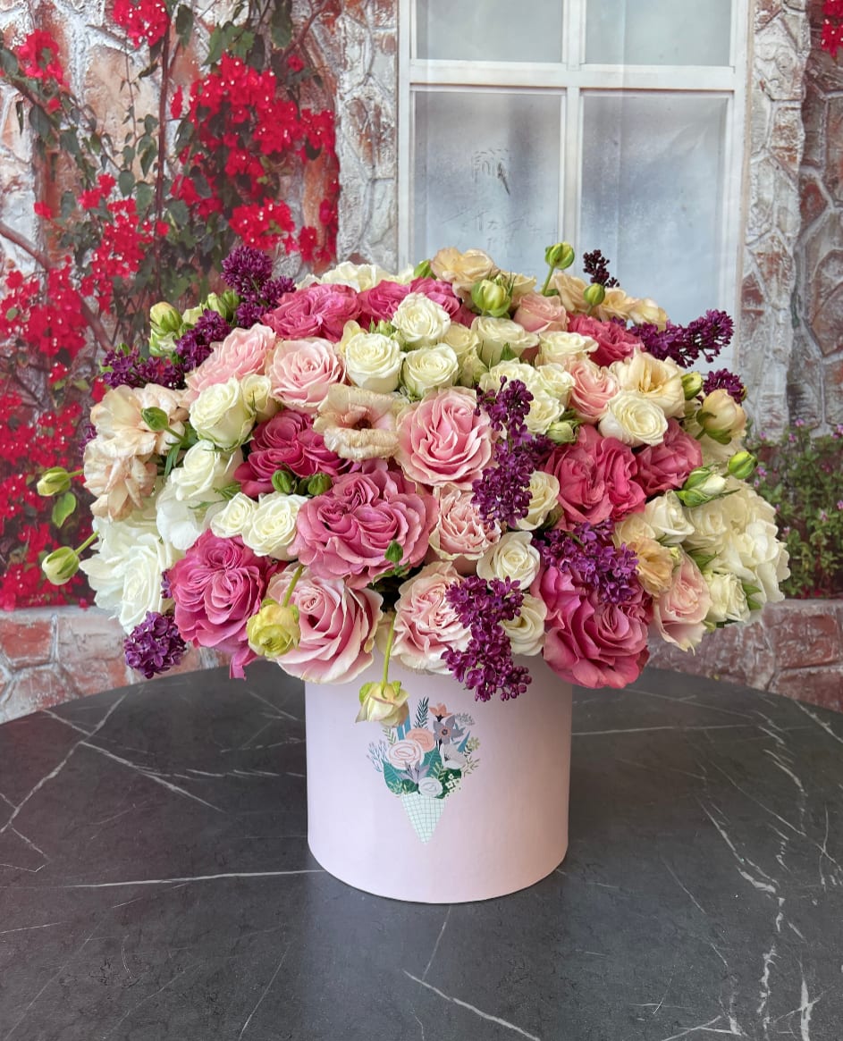 Large pink and cream rose arrangement in a pale box
