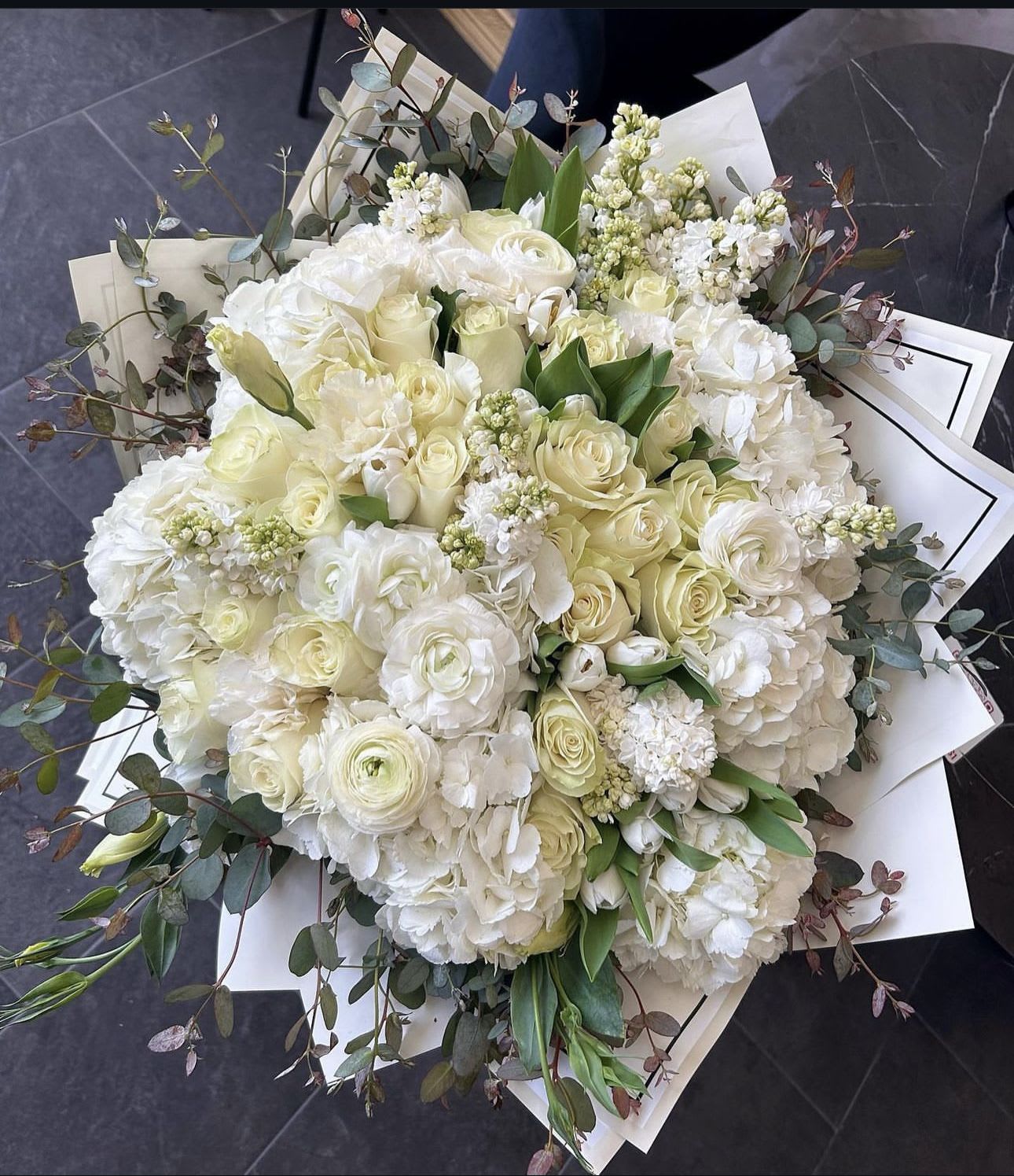 Large bouquet of white roses and hydrangeas with eucalyptus