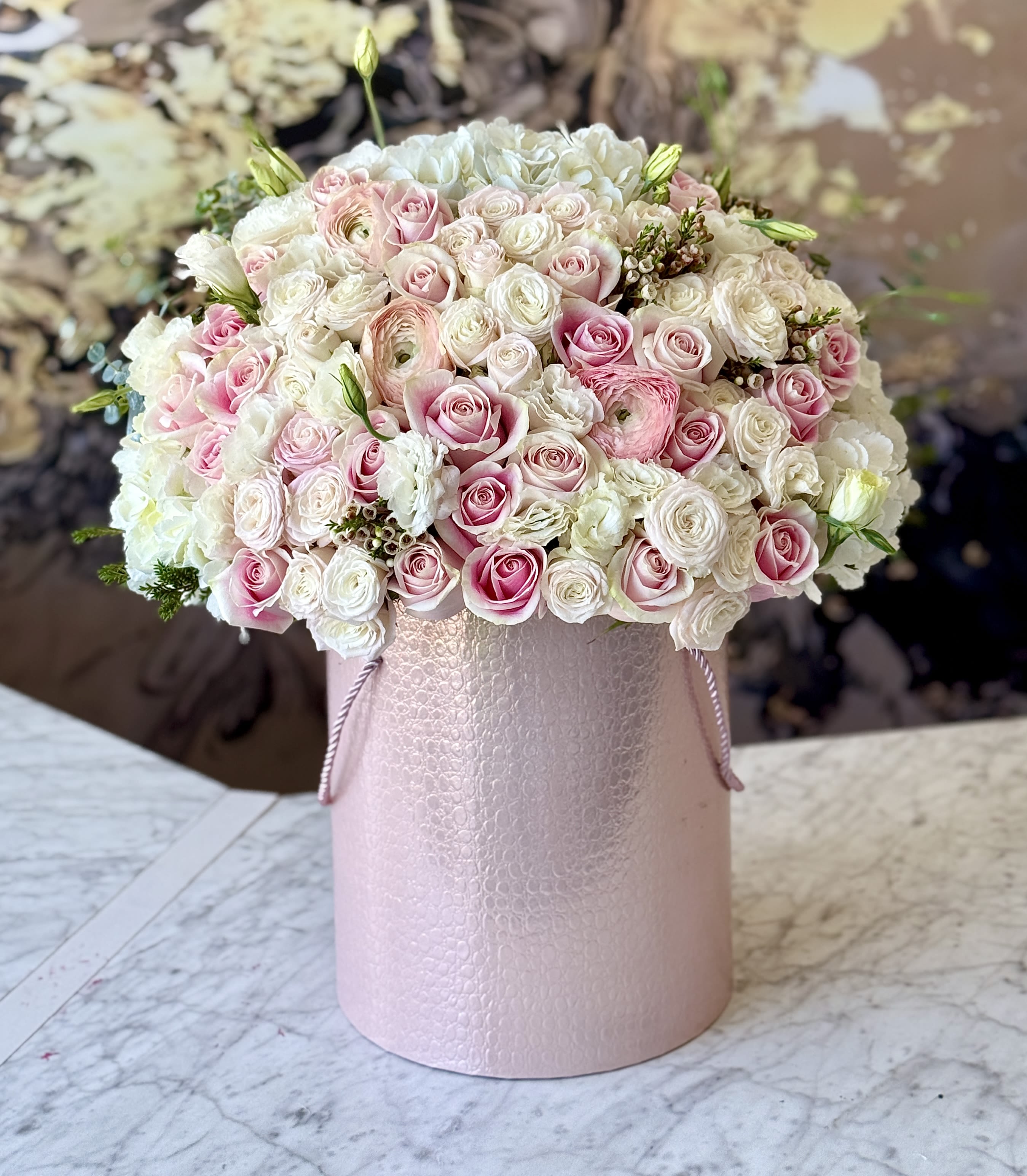 Pink and white rose bouquet in a pale pink hat box