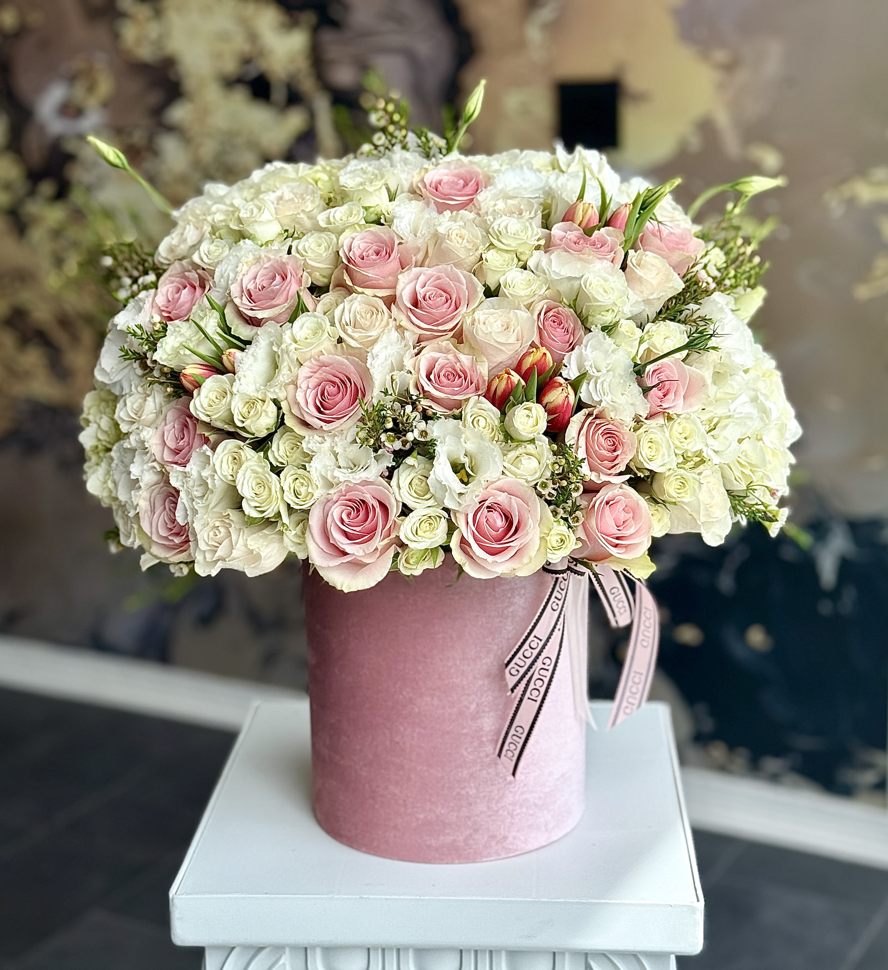 Pink and white rose bouquet in a pink hat box with ribbon