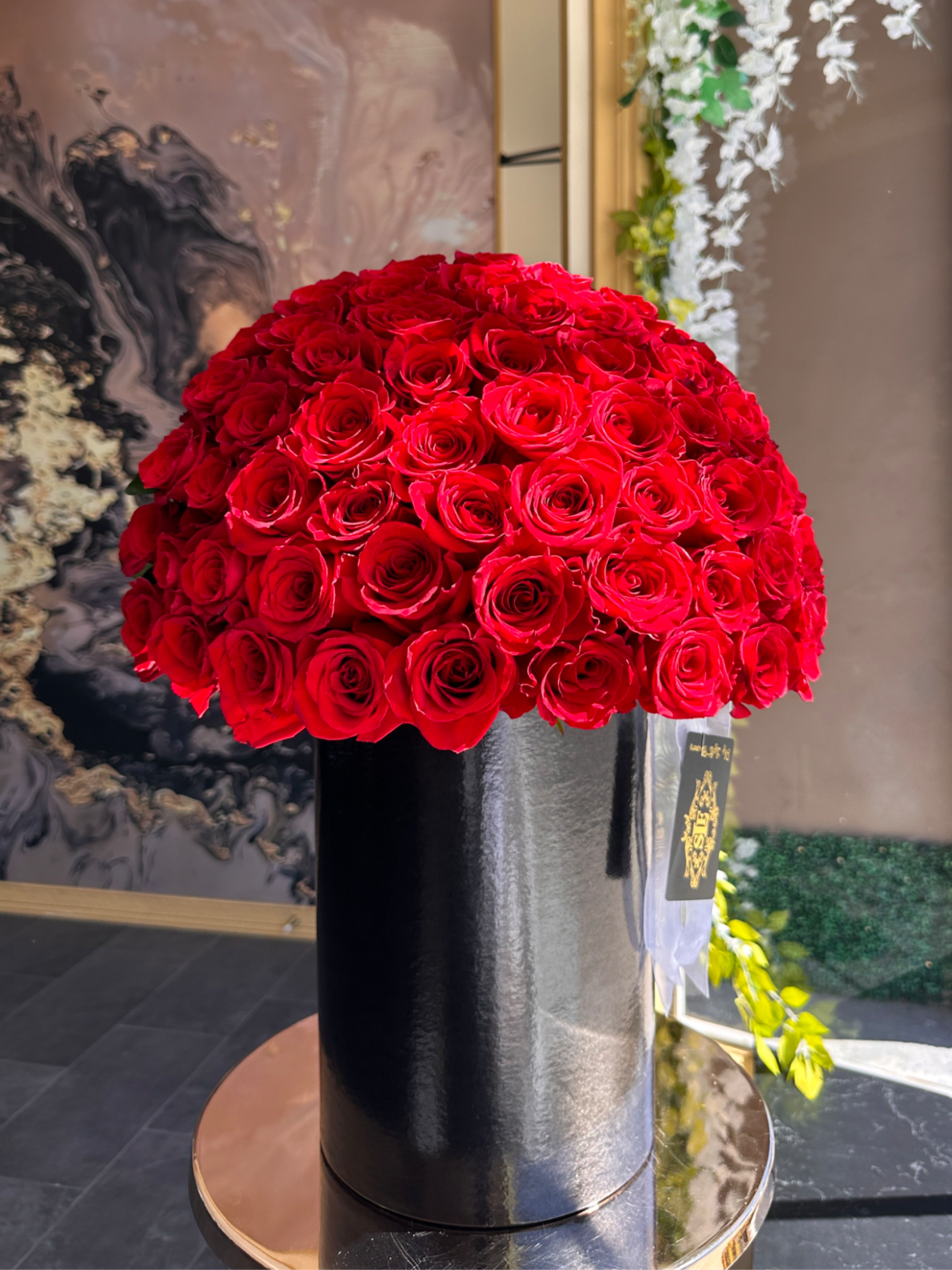 red envy - Brighten any space with our Elegant Flower Box Arrangement! Bursting with vibrant blooms, this stunning display combines seasonal favorites with lush fillers.   Housed in a chic, reusable container, it makes a perfect centerpiece for any occasion be it a gift or a treat for yourself. Elevate your decor with this captivating arrangement that brings joy and sophistication to your home or office. Order yours today and let the beauty of flowers inspire you! 