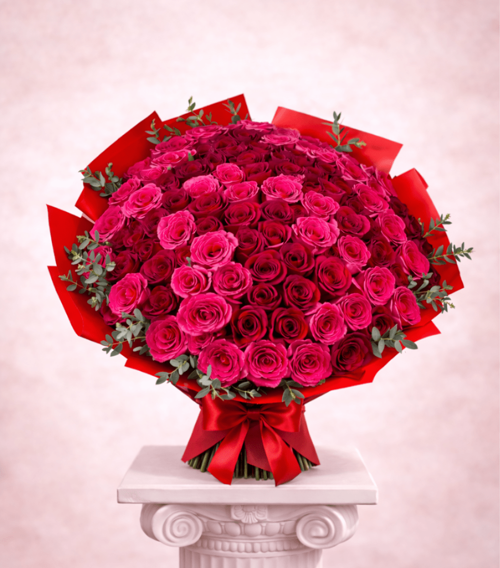 Large bouquet of pink and red roses wrapped in red paper