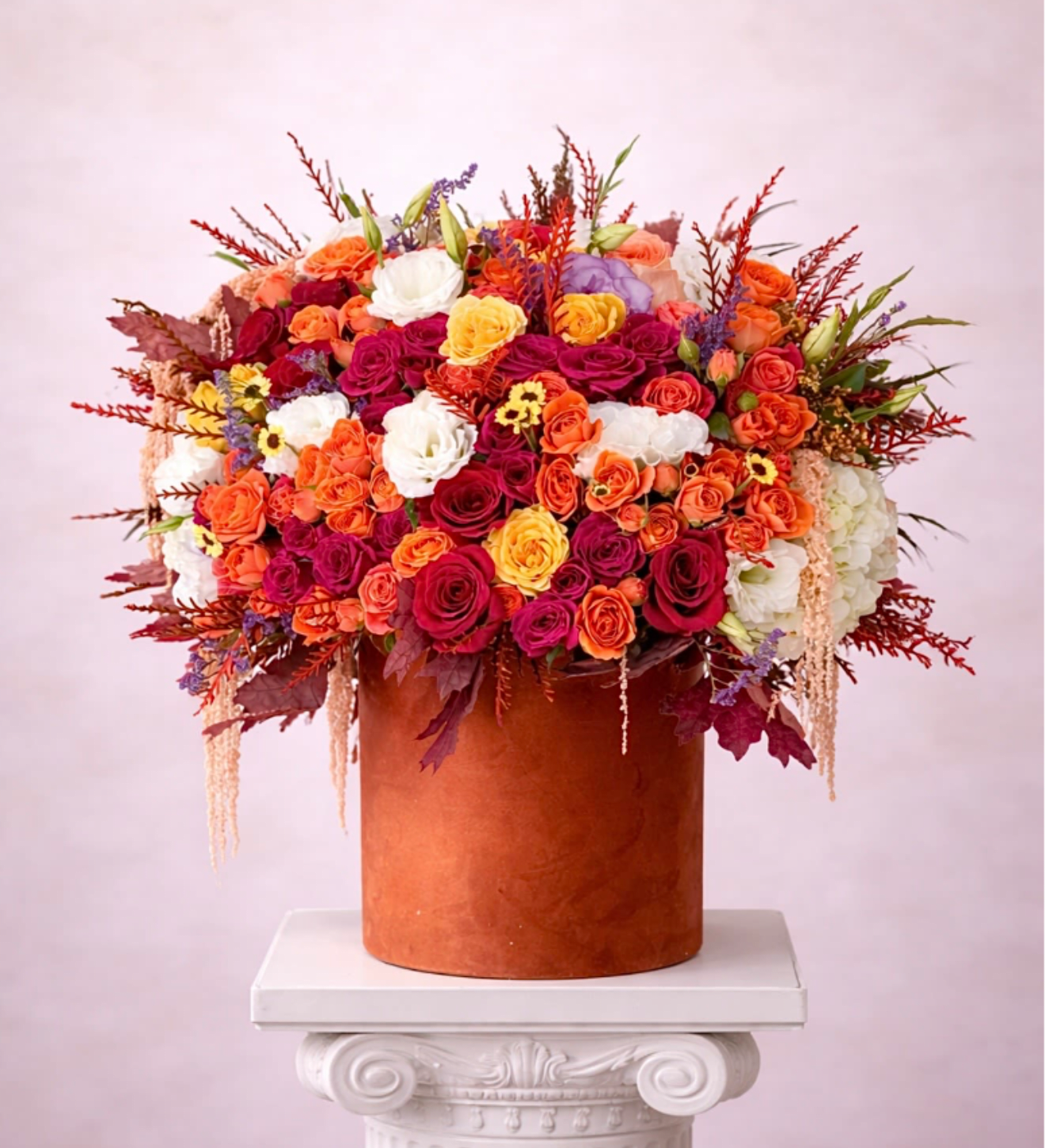 Amber Bloom - Brighten any space with our Elegant Flower Fall Box Arrangement! Bursting with vibrant blooms, this stunning display combines seasonal favorites with lush fillers.  Housed in a chic, reusable container, it makes a perfect centerpiece for any occasion be it a gift or a treat for yourself. Elevate your decor with this captivating arrangement that brings joy and sophistication to your home or office. Order yours today and let the beauty of flowers inspire you!