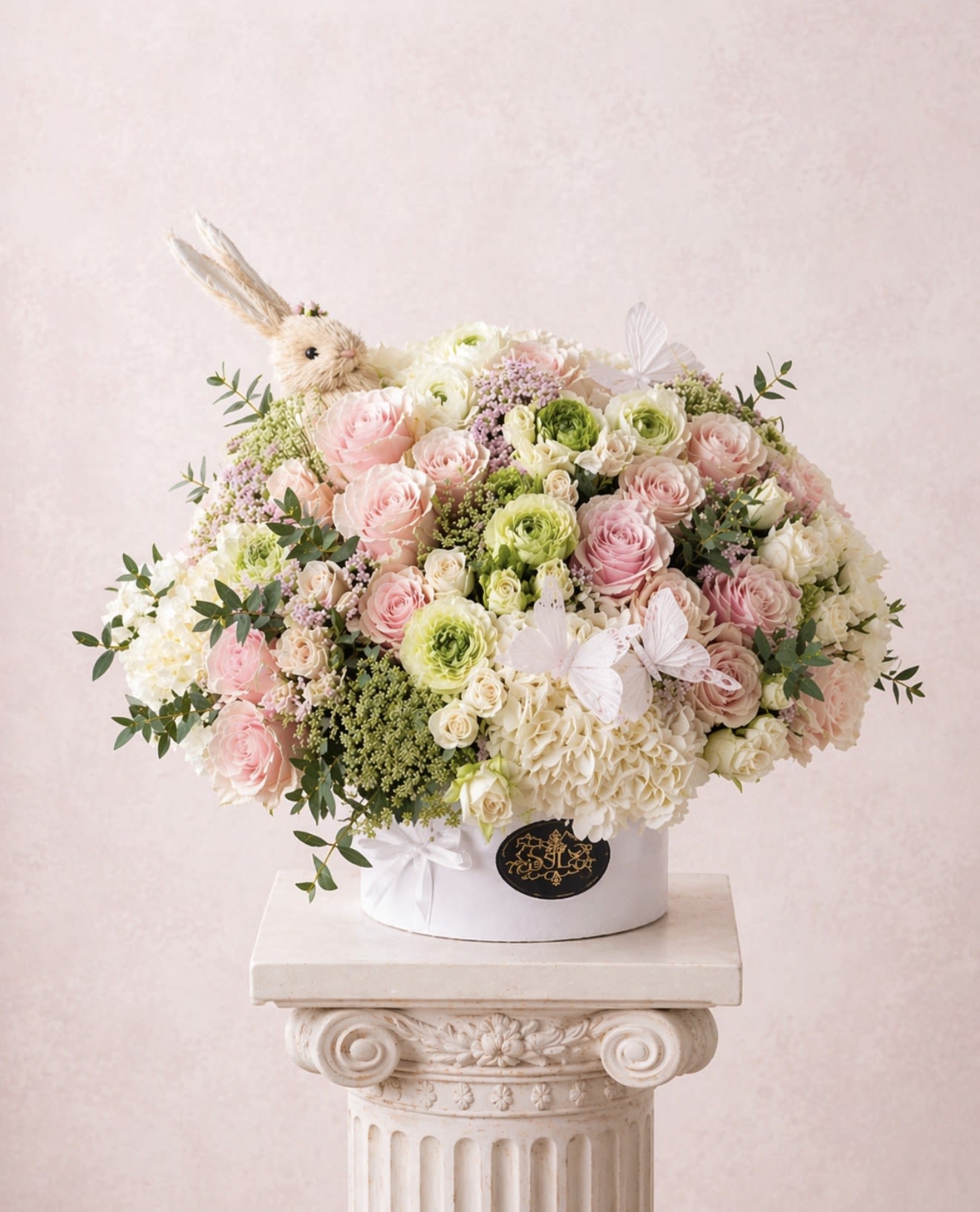 BUNNY - Brighten any space with our Elegant Flower Box Arrangement! Bursting with vibrant blooms, this stunning display combines seasonal favorites with lush fillers.   Housed in a chic, reusable container, it makes a perfect centerpiece for any occasion be it a gift or a treat for yourself. Elevate your decor with this captivating arrangement that brings joy and sophistication to your home or office. Order yours today and let the beauty of flowers inspire you!