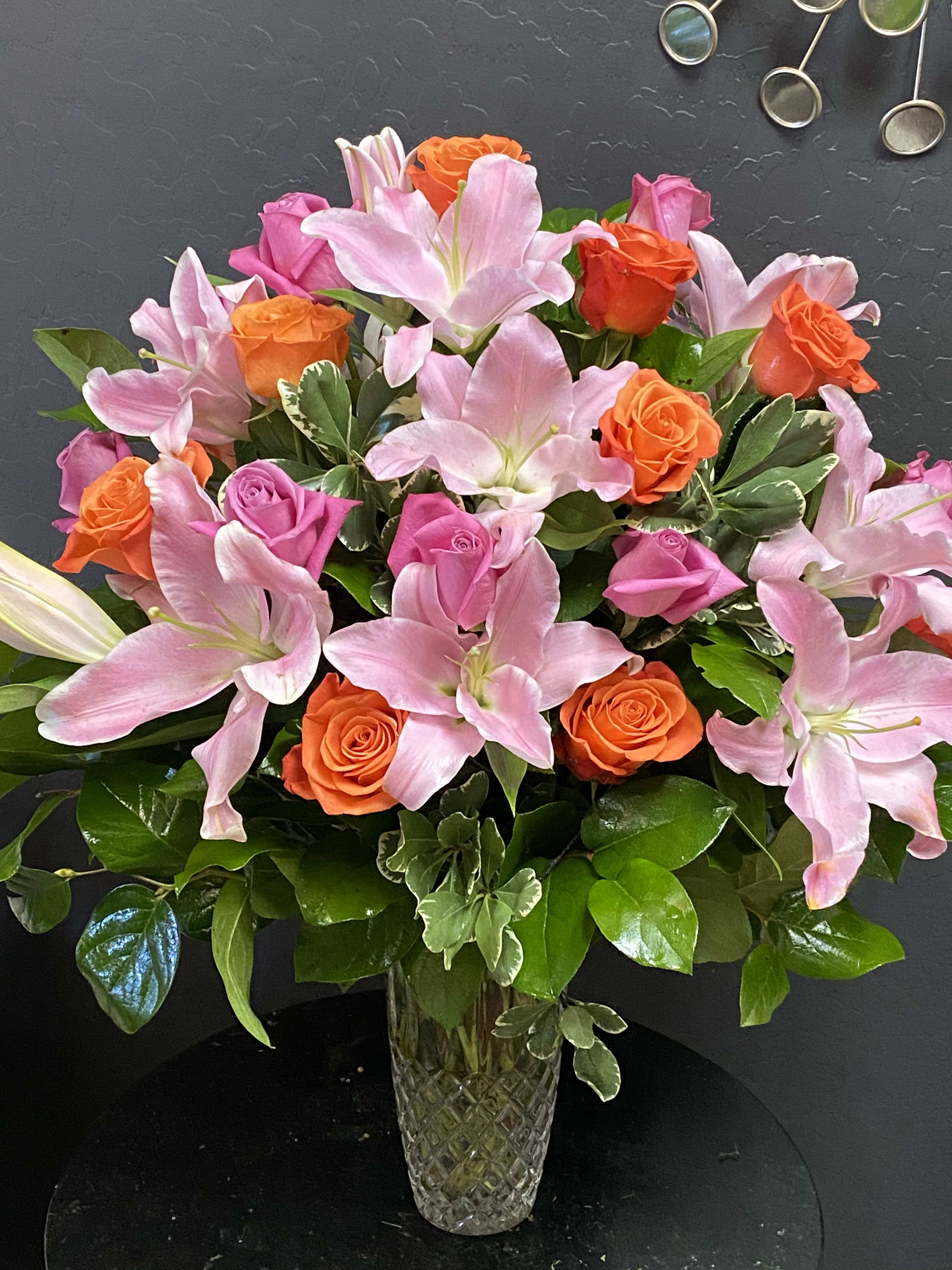 The FTD Sweetly Stunning Luxury Bouquet - Simply grand in color and style this artisan design brings together a favorite color combination of orange against pink and succeeded in making it both modern and sophisticated. A celebration of life love and every wonderful moment along the way this bright and showy arrangement exhibits a soft fragrance from it’s blooms while sitting in a clear glass vase with a modern flair that adds further interest and style to its overall look. When you send this bouquet you send happiness