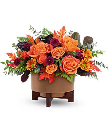 Fall For Copper Centerpiece - Turn up the autumn glow with the Fall For Copper Centerpiece. Bursting with vibrant orange blooms and rich fall foliage in a modern copper-finished planter, this centerpiece is a warm and stylish way to celebrate the season.