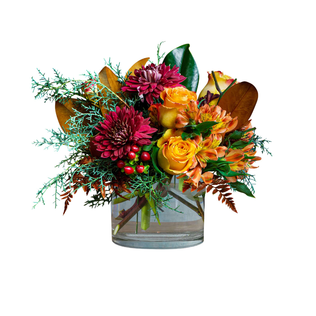 Mixed bouquet of yellow roses and burgundy flowers in a glass vase