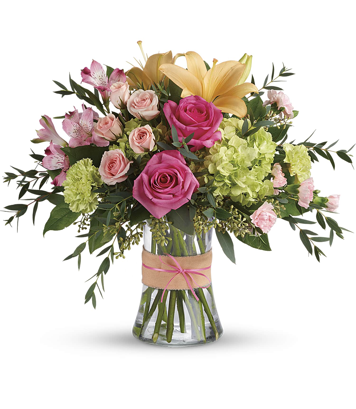 Pink and peach flowers arranged in a glass vase with a burlap ribbon