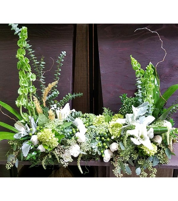White and green floral arrangement with tall upright blooms