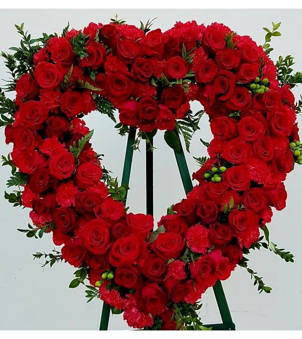 Heart-shaped red rose wreath on a standing easel