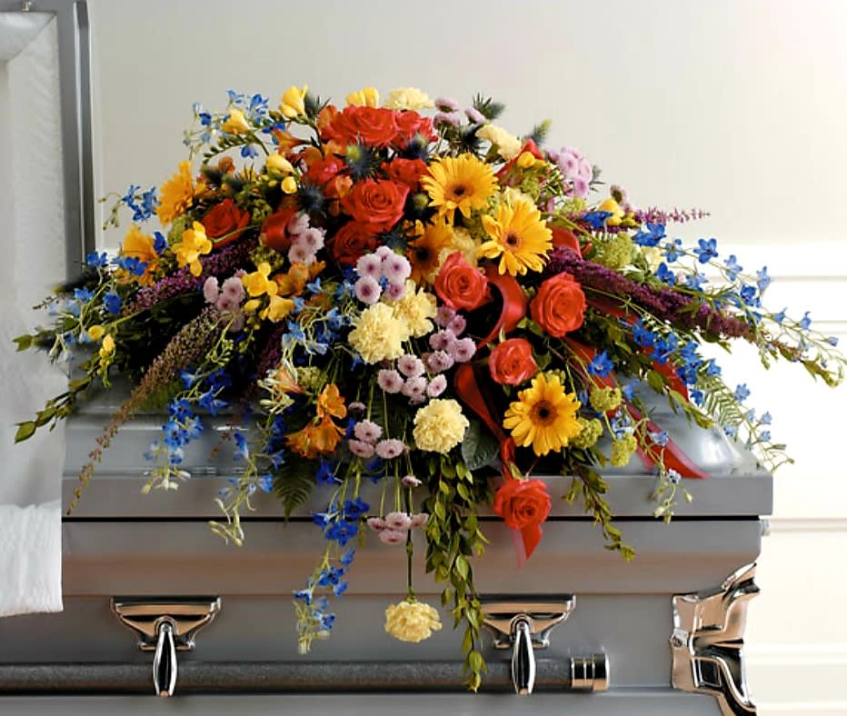 Colorful Memories Casket Spray - A time-honored tribute, this cascading blaze of color celebrates your love one's life in a most uplifting way.