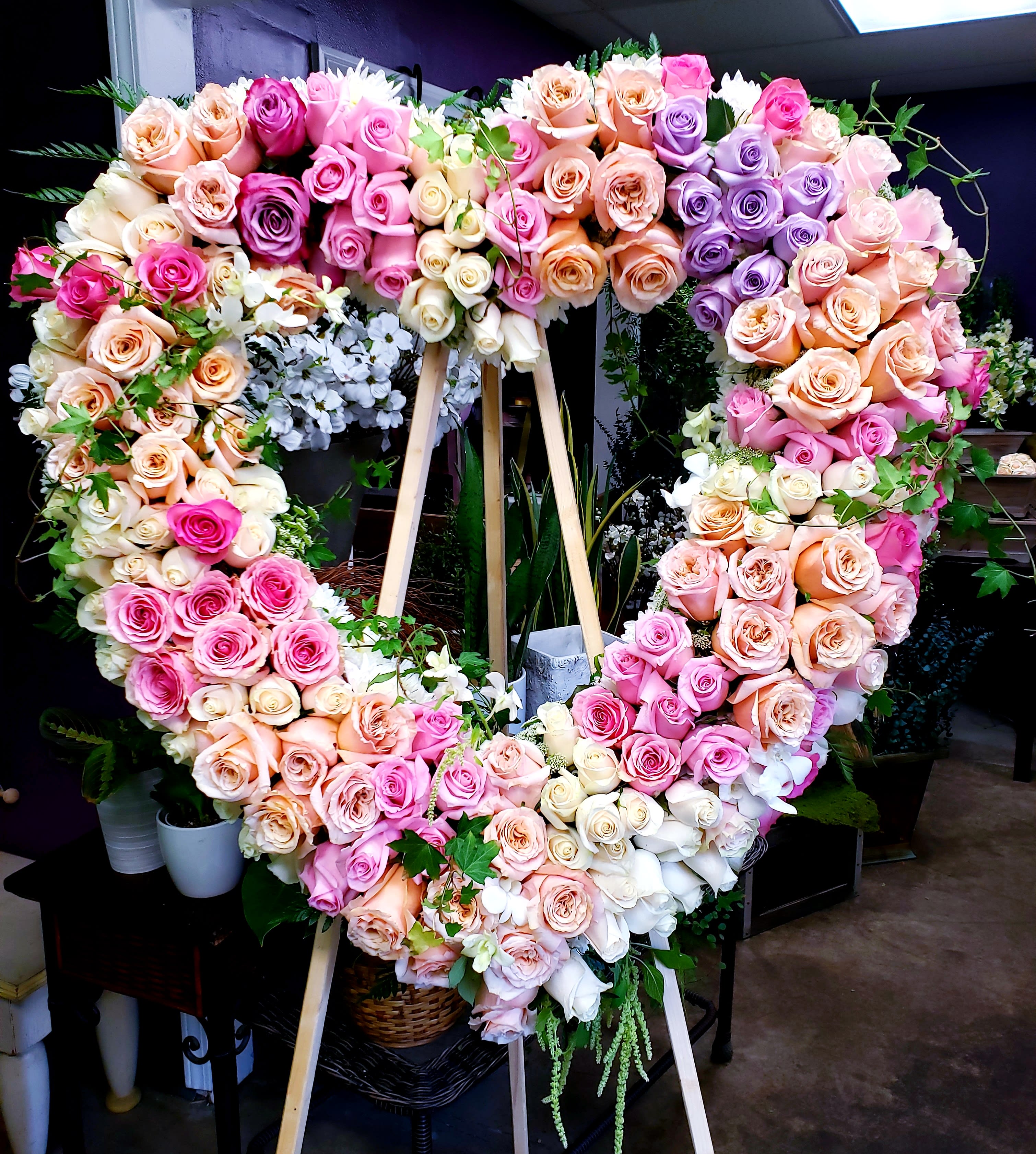 Heart-shaped rose wreath on a wooden easel