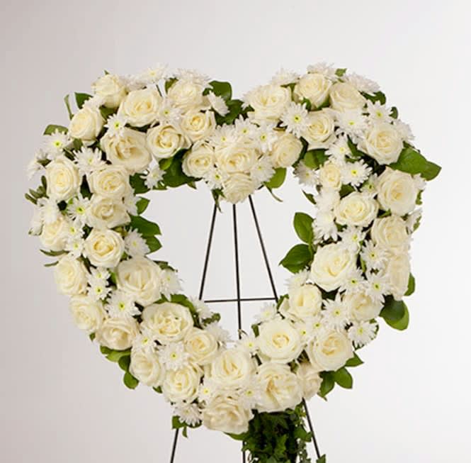 Love in our Hearts by BloomNation™  - An all white tribute, this heart shaped easel shows your everlasting love. Featuring a variety of white flowers and greenery, this heart with a trail of ivy compliments the beauty of life.    18in w
