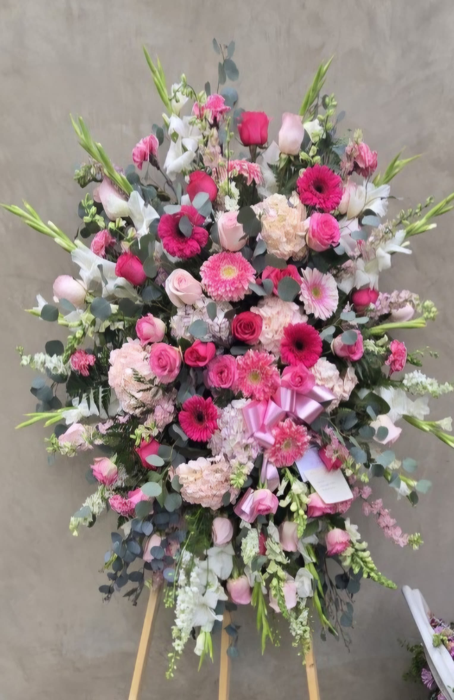 Large pink and white floral standing spray on an easel