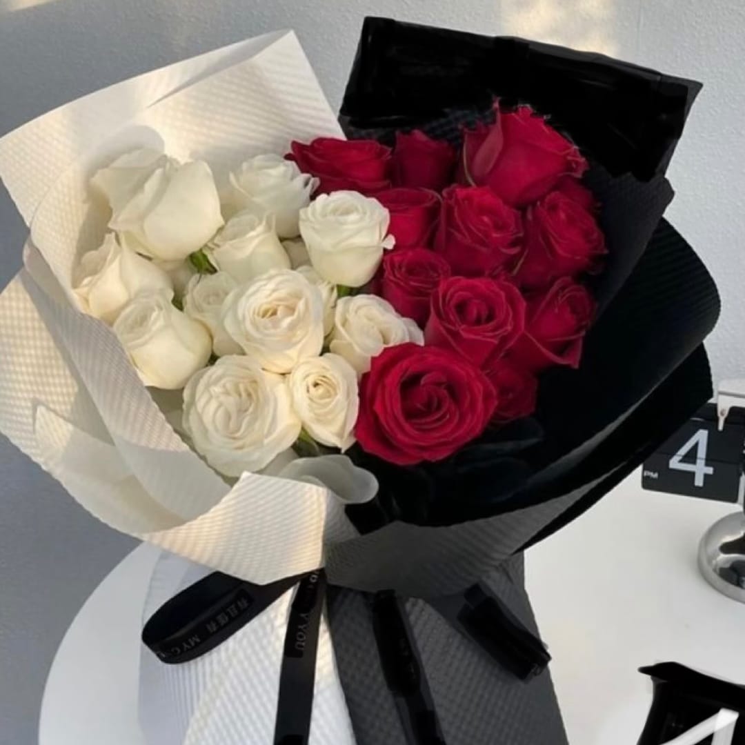 Bouquet of red and white roses wrapped in black and white paper