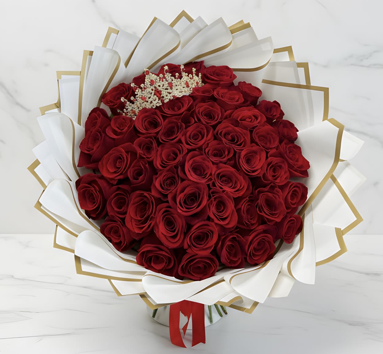 Bouquet of red roses wrapped in white and gold paper