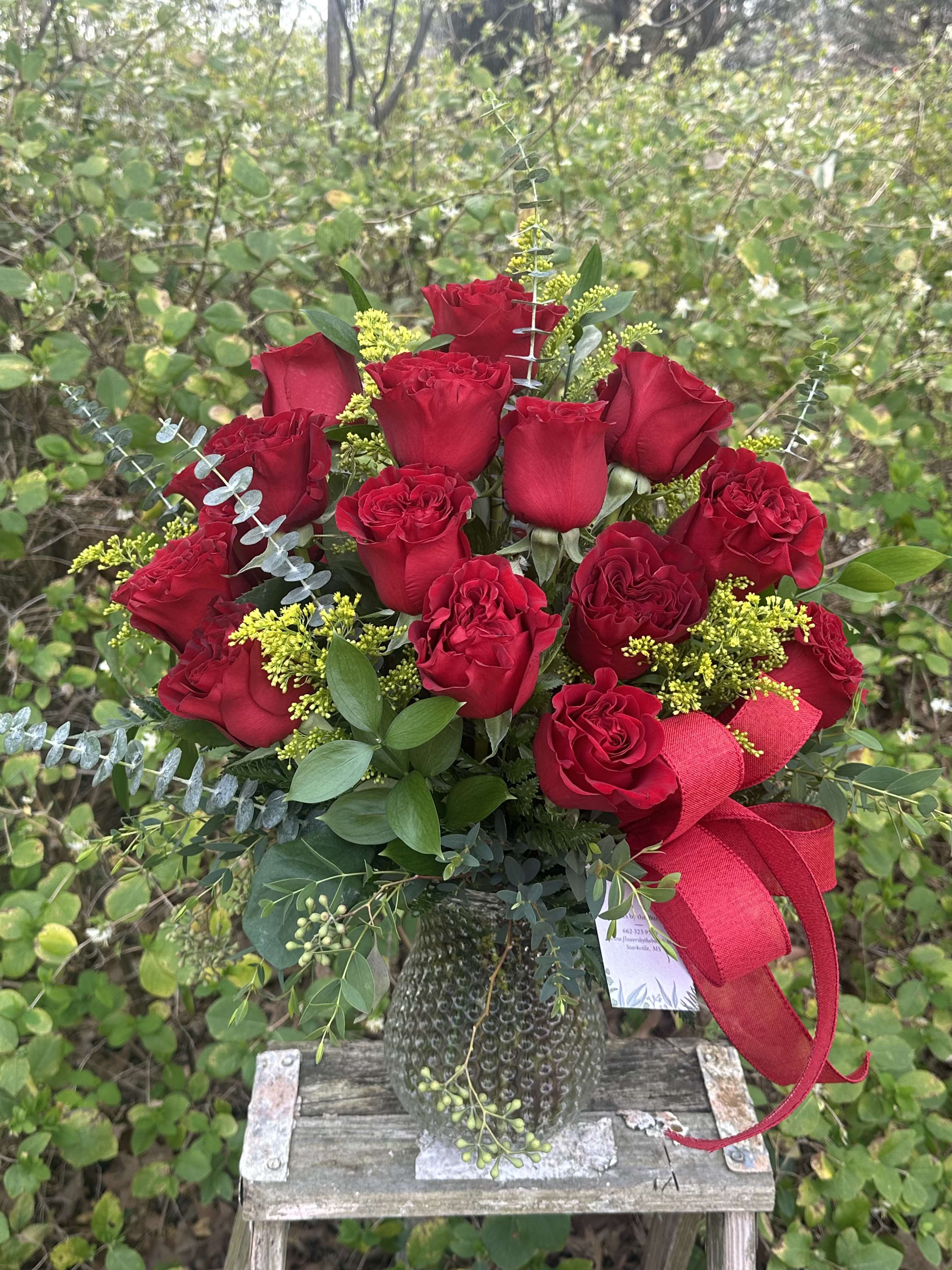 Compact Two Dozen Roses - Our classic two dozen roses but arranged in a compact style. If you love a garden feel, a compact arrangement is perfect for you! Please call us at 662-323-9580 to discuss color options for our roses. Otherwise, we will use red as a default.