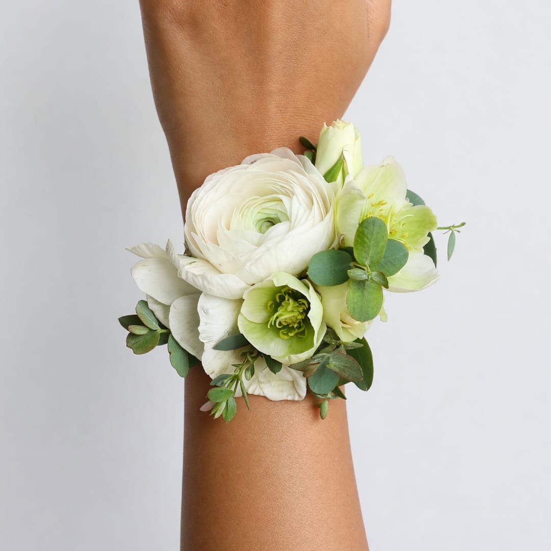 White and pale green wrist corsage with flowers and greenery