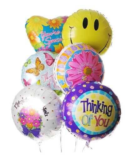 Cluster of colorful foil balloons with smiley and thank-you messages