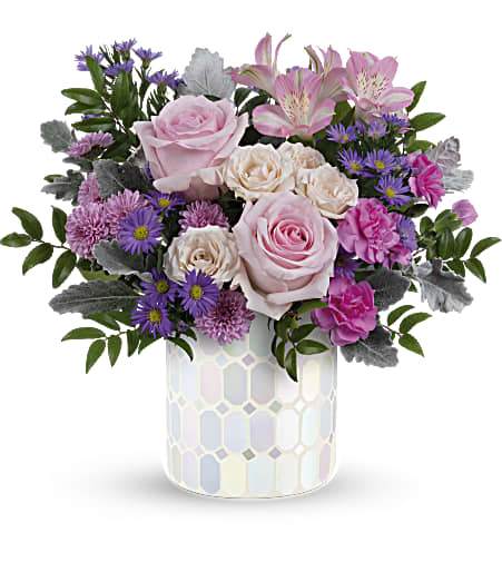 Pink roses and purple flowers in a patterned vase