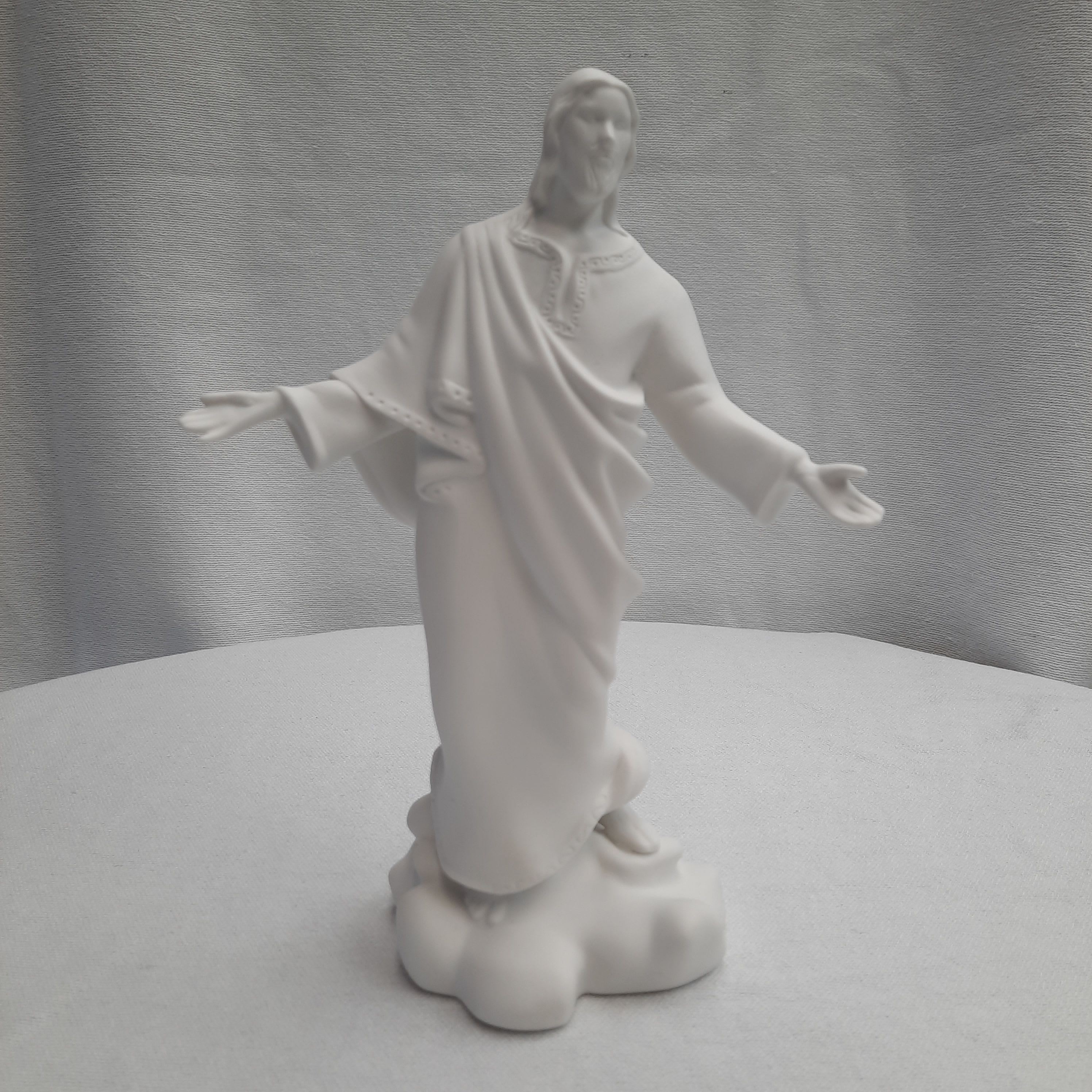 White religious statue of Jesus with outstretched arms