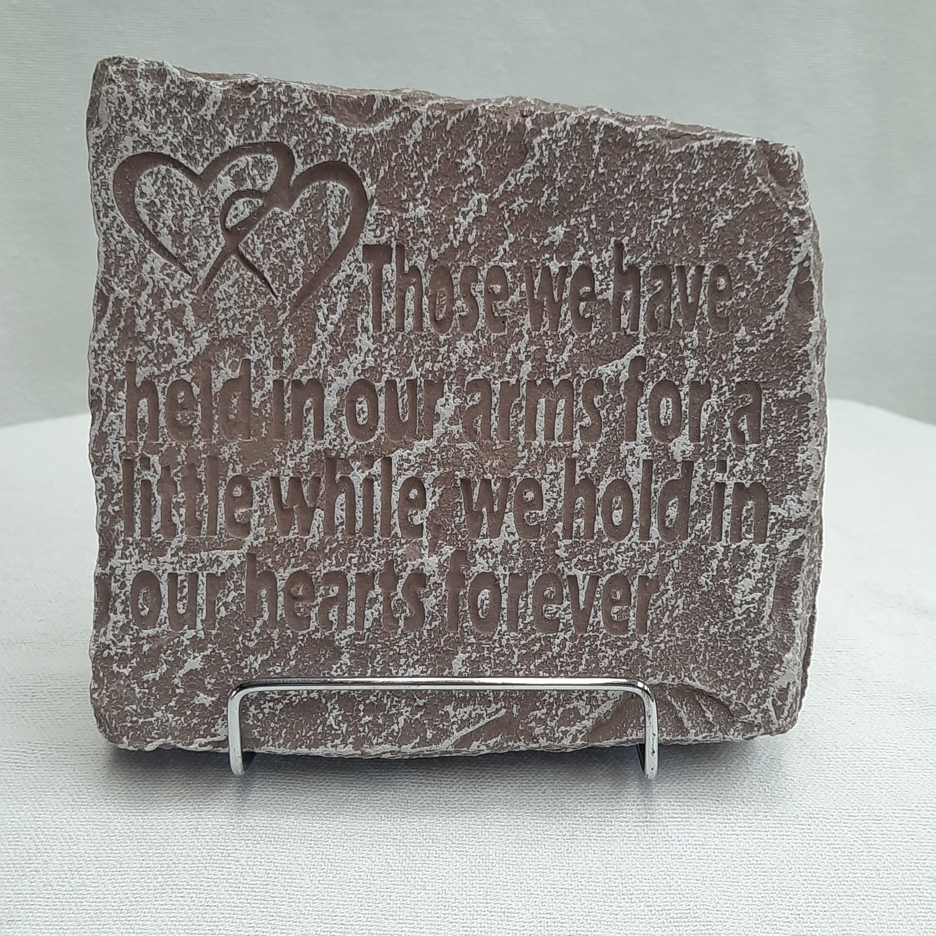 Engraved stone plaque with a heart design and memorial quote