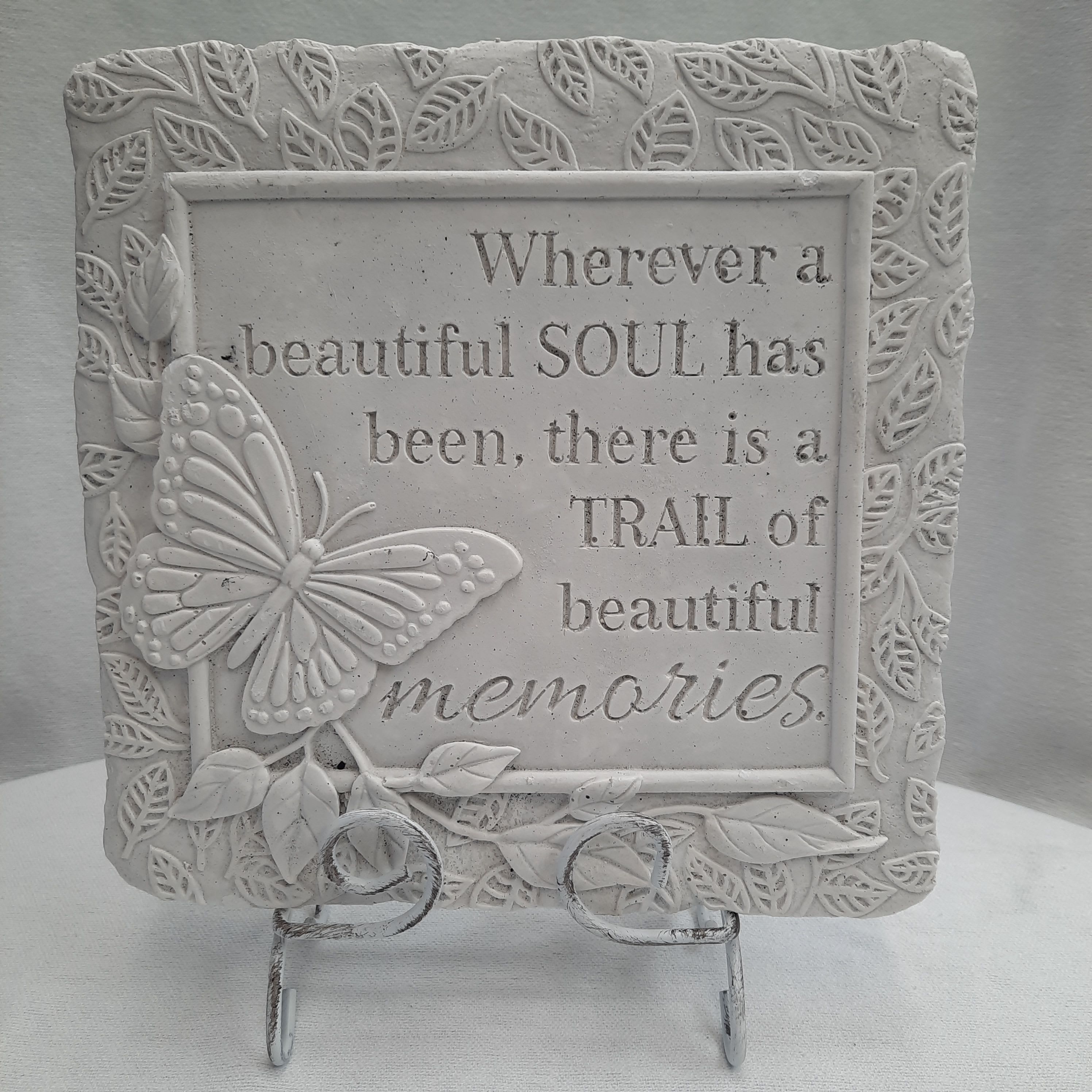 Decorative plaque with a butterfly and memorial quote on a stand